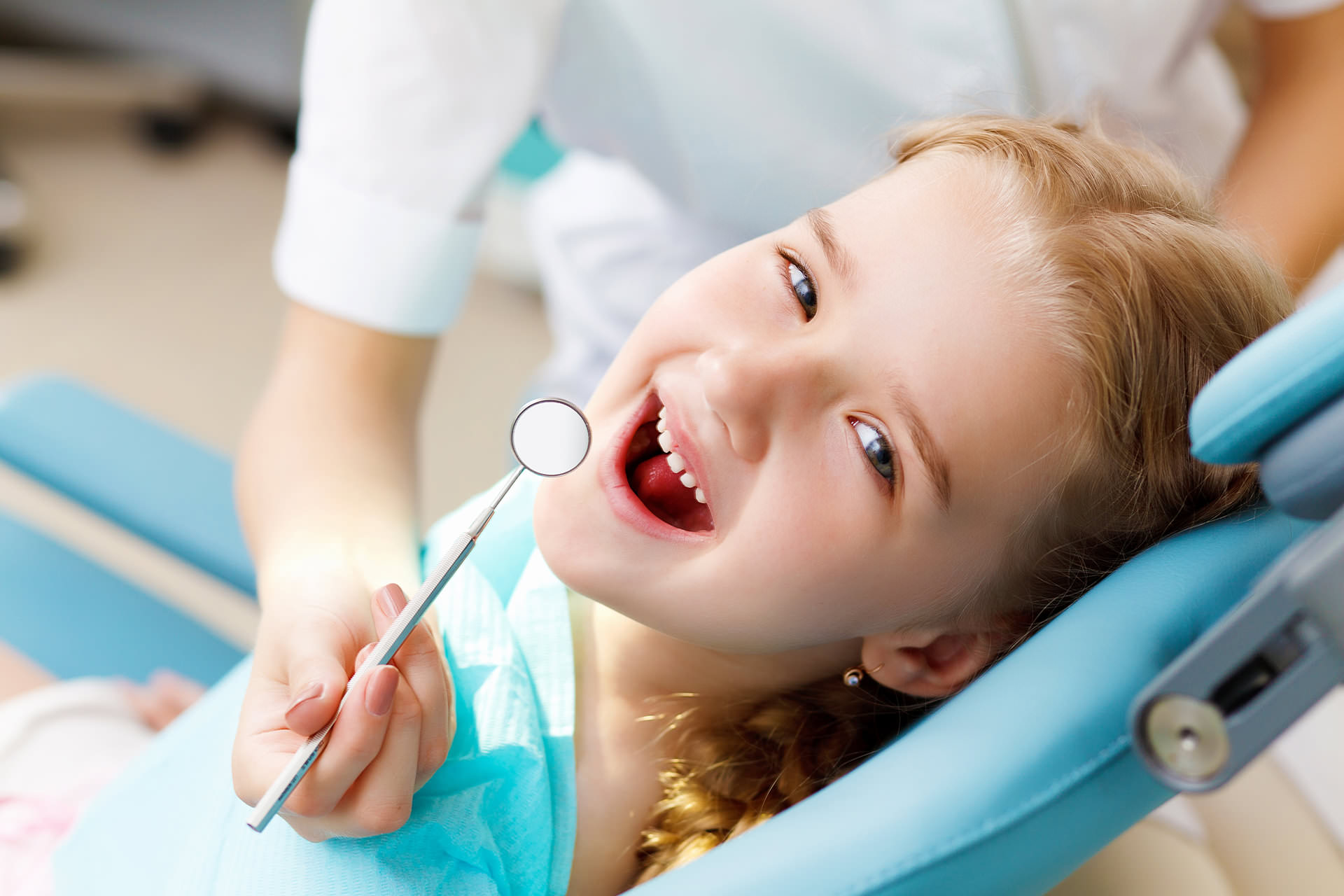 Girl in dental chair slide for Pediatric Dentist Dr. Mauricio Marcushamer in Downtown San Antonio, TX